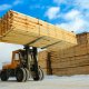 lumber being loaded by a forklift