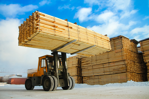 lumber being loaded by a forklift
